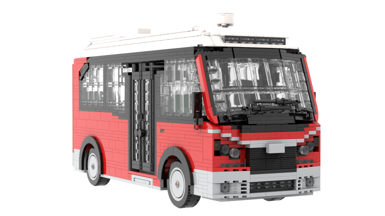 Autobús de juguete de ladrillos, con diseño en rojo y negro, con detalles en blanco.